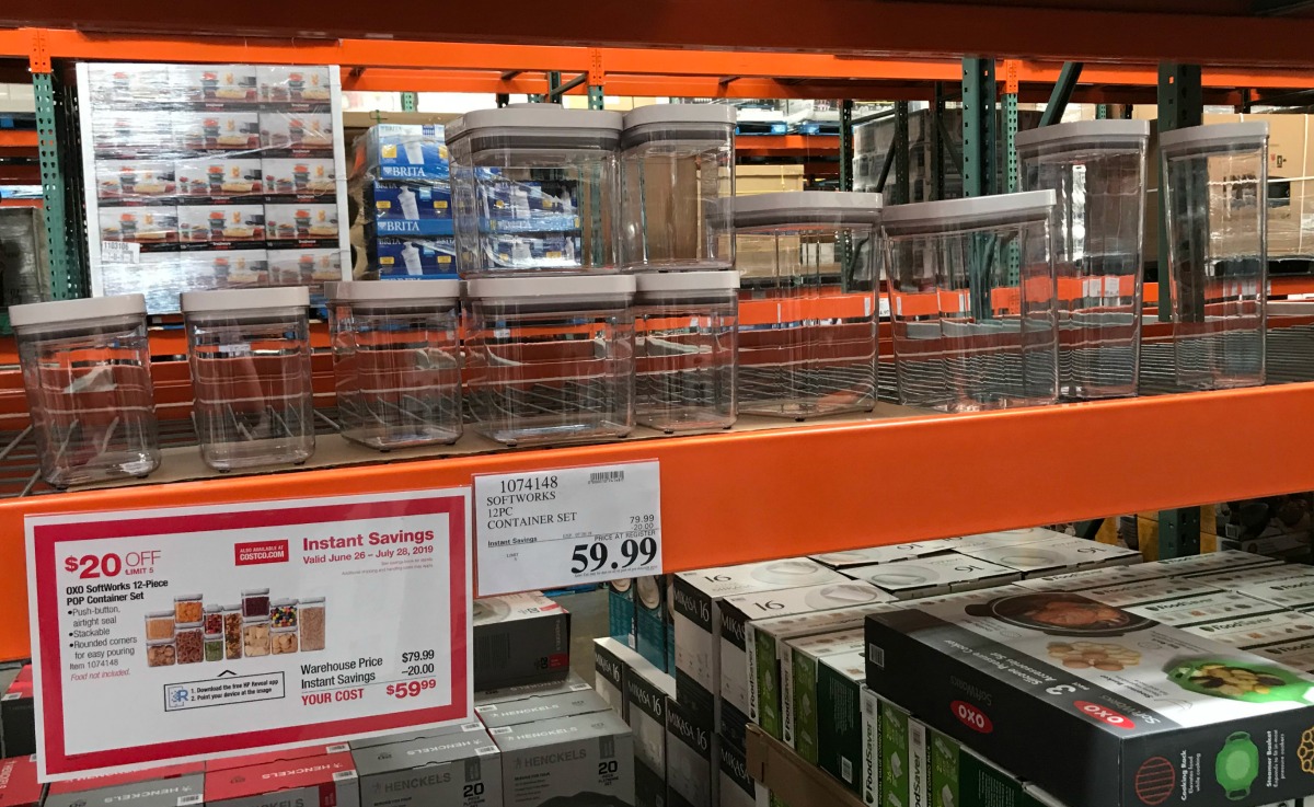 OXO clear plastic storage containers lined up on a Costco store shelf