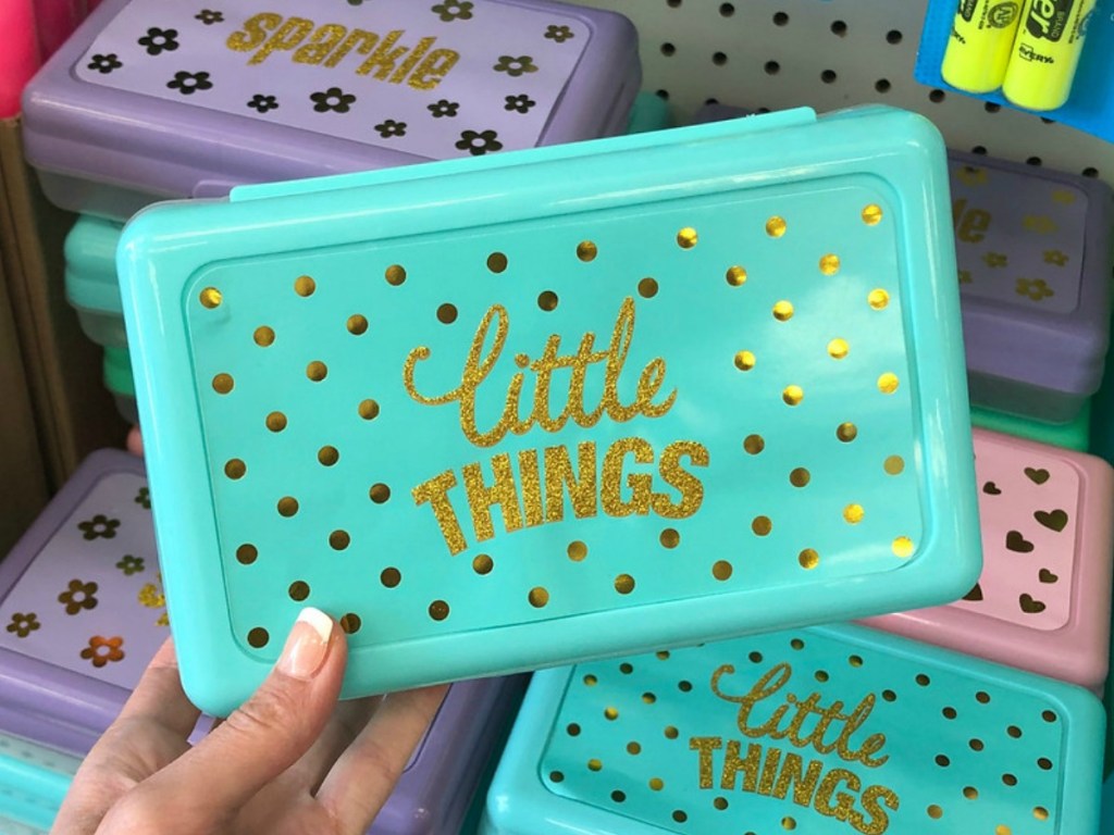 hand holding aqua colored pencil box in store