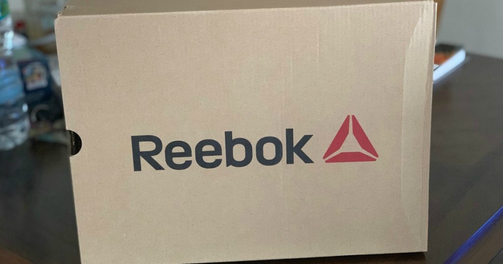 box on table with Reebok logo on it