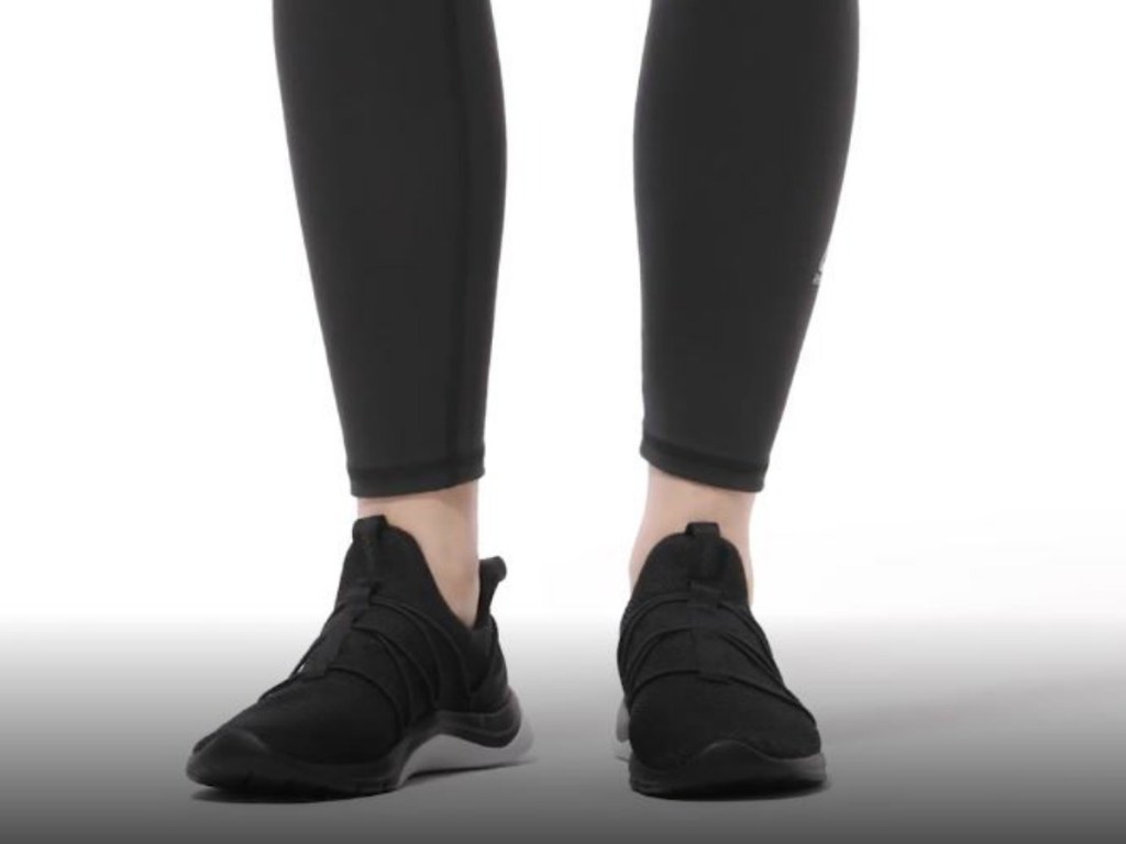 woman's legs with black shoes