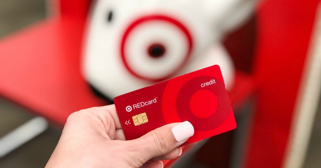 Hand holding a Target REDcard in Target store in front of display