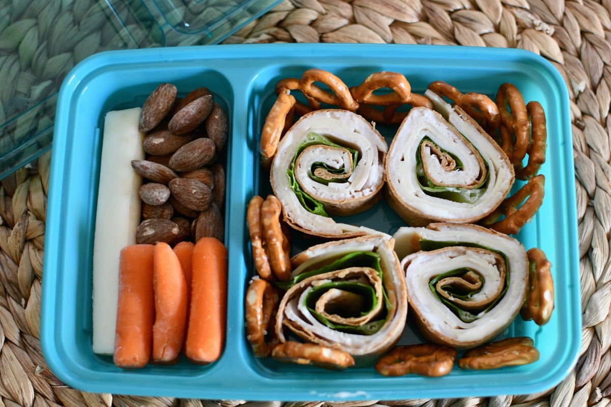 turkey and cheese roll-up wrap in a lunch container 