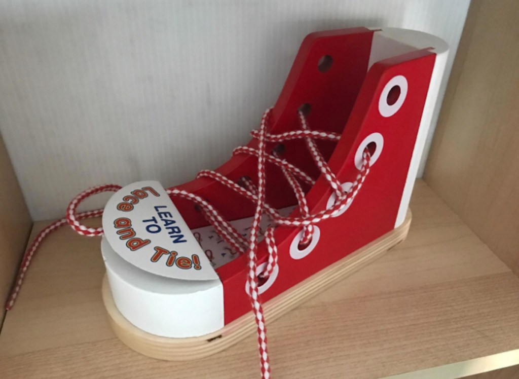 red and white wooden shoes with laces 