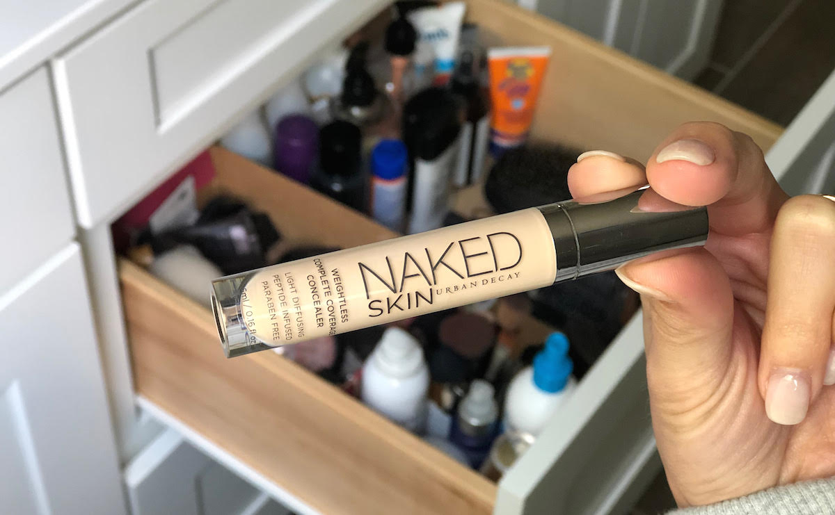 hand holding urban decay concealer 