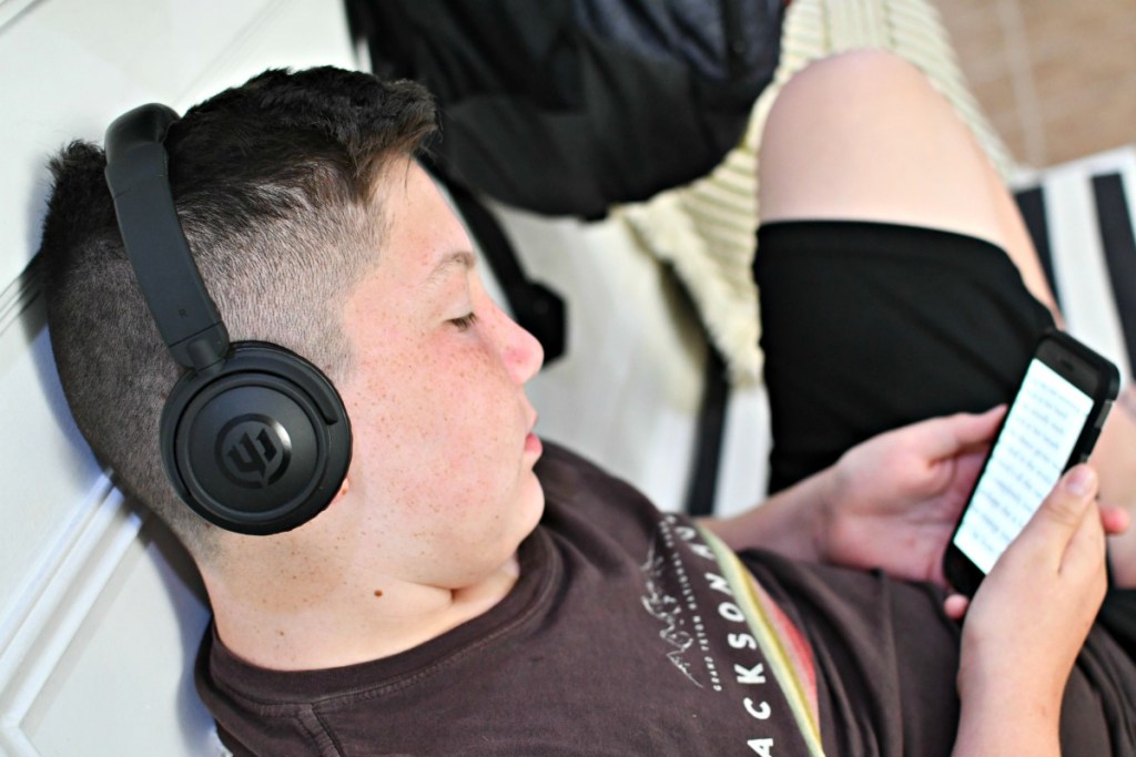 boy listening to audio books using headphones 