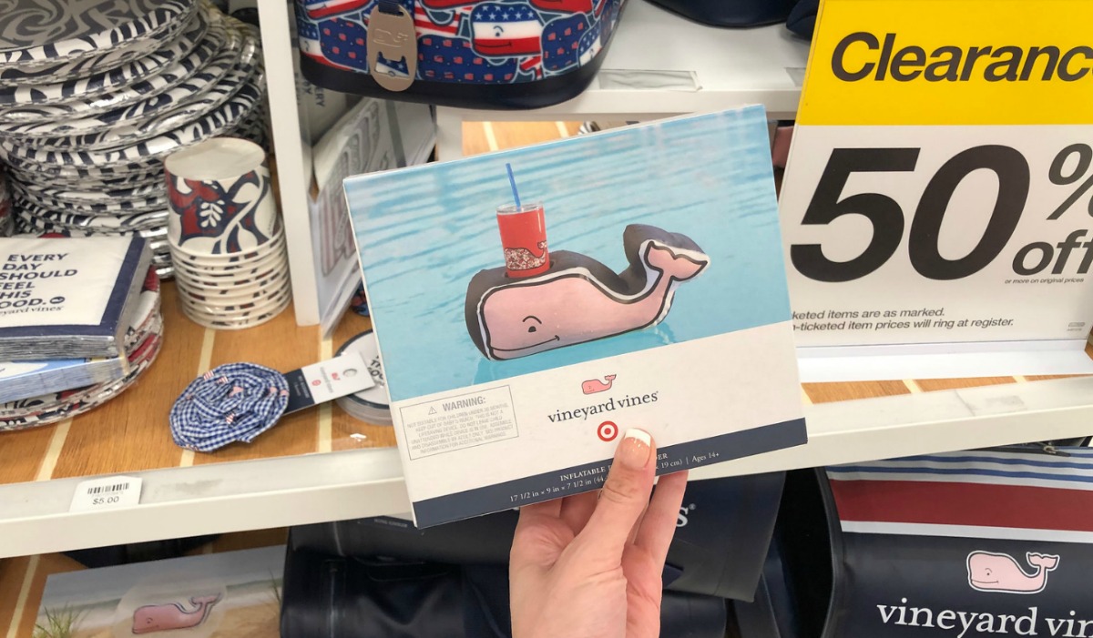 hand holding whale drink holder box with 50% clearance sign behind it