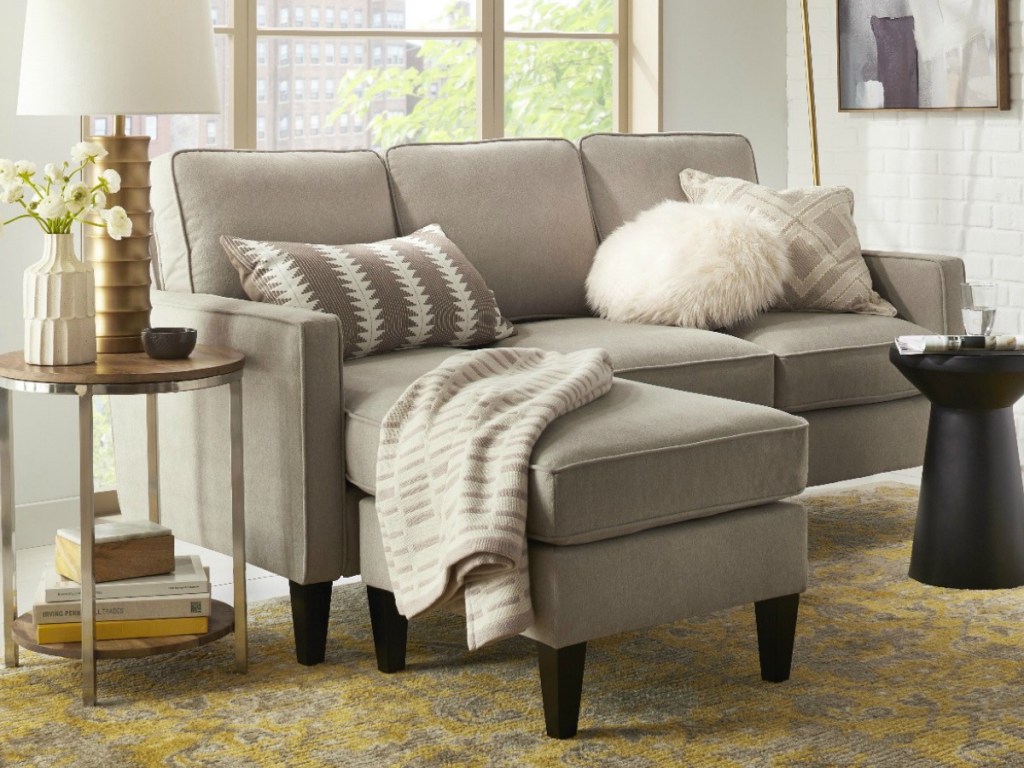couch and small tables on yellow rug in home