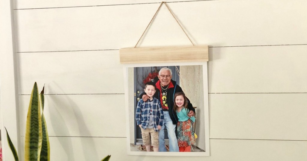 wood hanger hanging on wall with picture of kids and grandpa