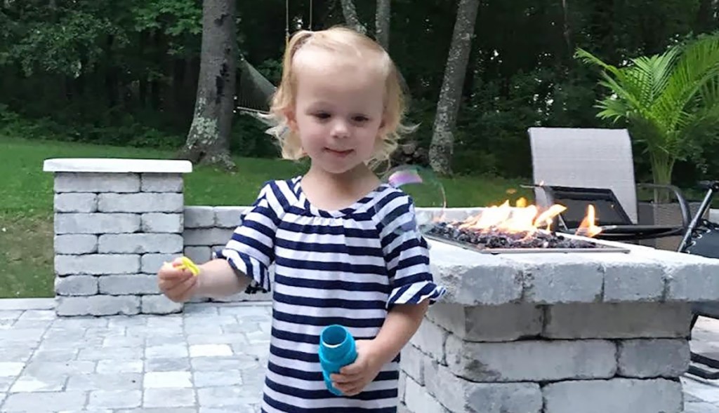 young girl playing with bubbles