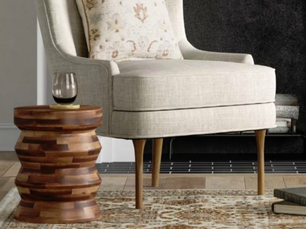 wooden drum used as side table by chair
