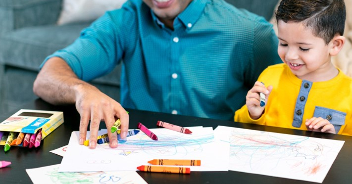 father and son using Crayola triangular crayons