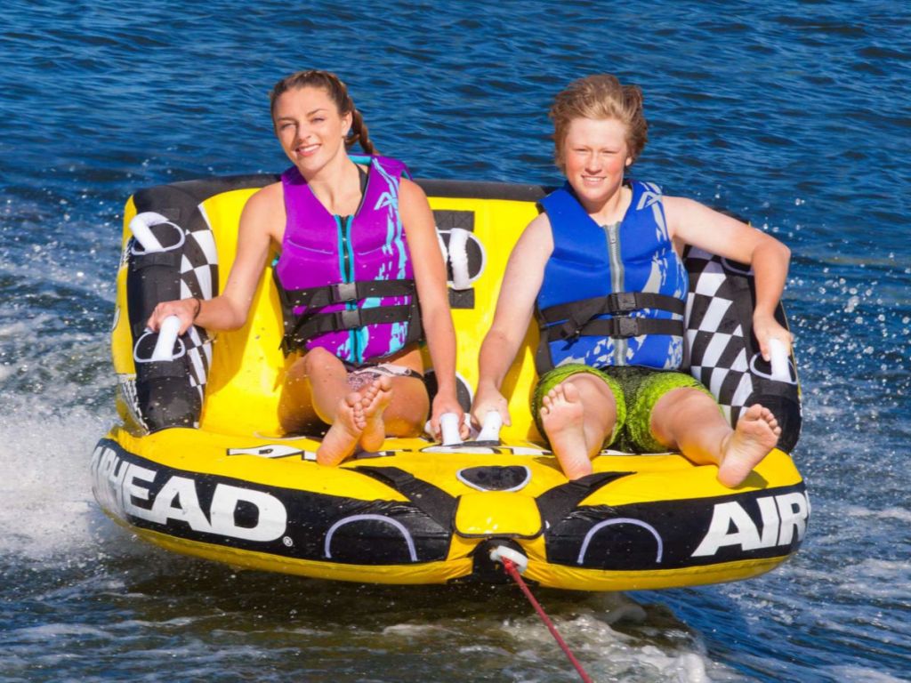 2 people on Airhead Pit Stop 2-Person Towable Tube on the water