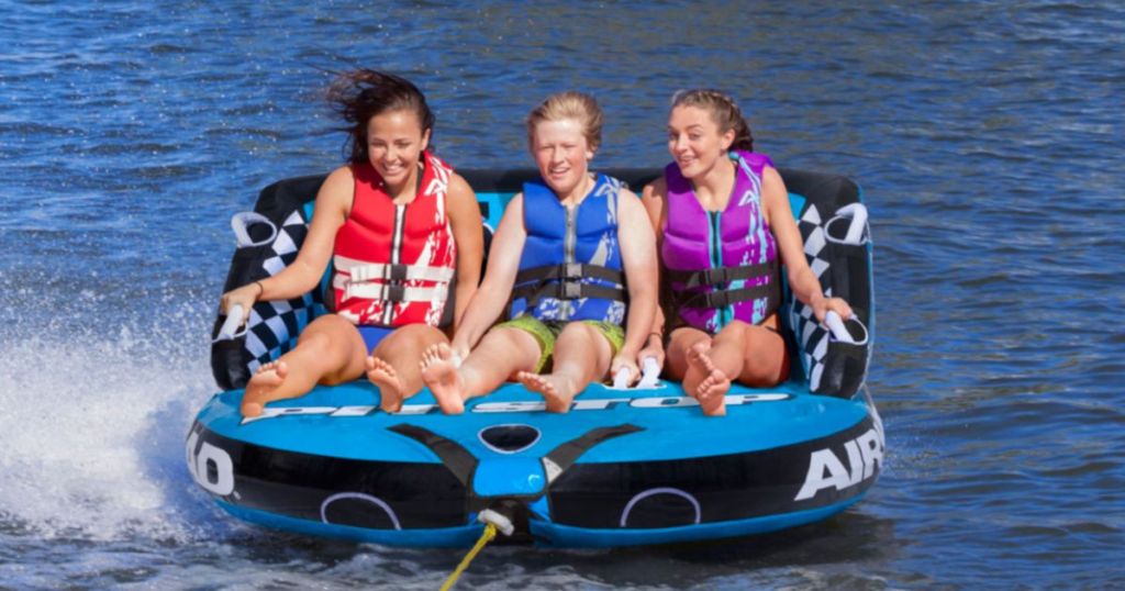 3 people on Airhead Pit Stop 3-Person Towable Tube on the water