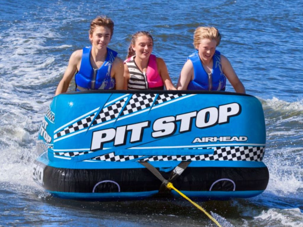 3 people on Airhead Pit Stop 3-Person Towable Tube on the water