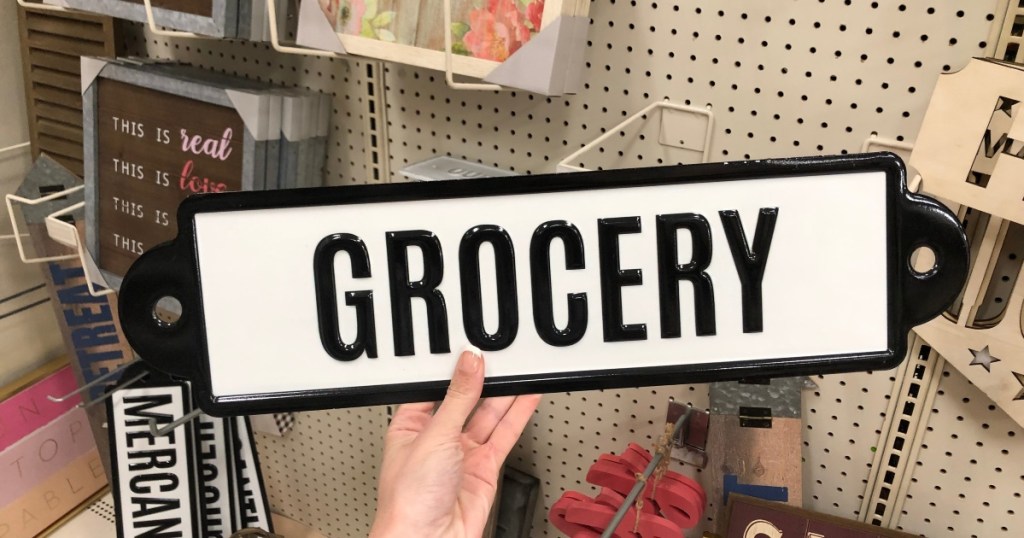 woman holding ashland spring grocery sign