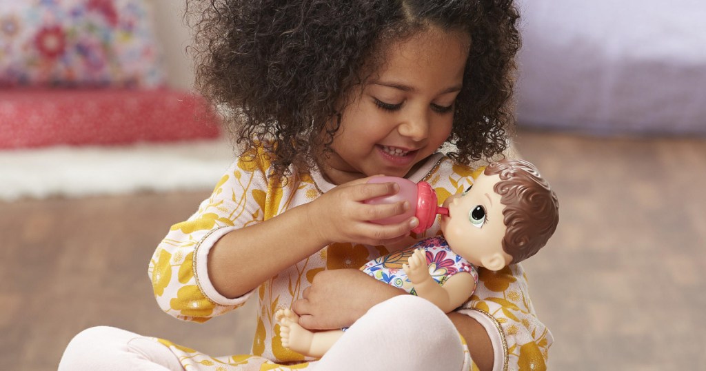 girl holding baby alive doll