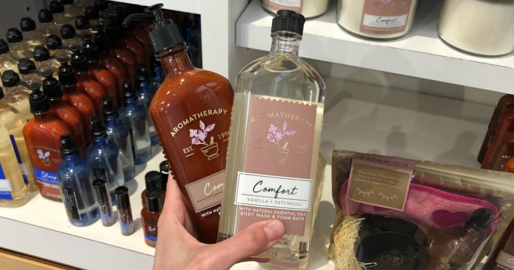 Two Bath & Body Works Aromatherapy products in hand in store