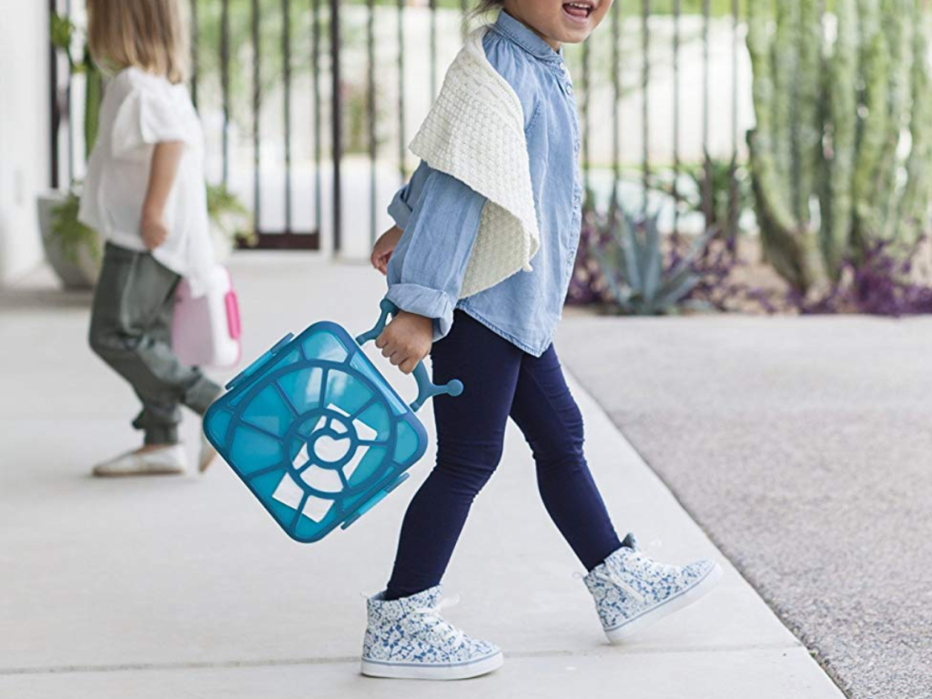 Boon Bento Blue Snail Lunch Box of child holding box and walking