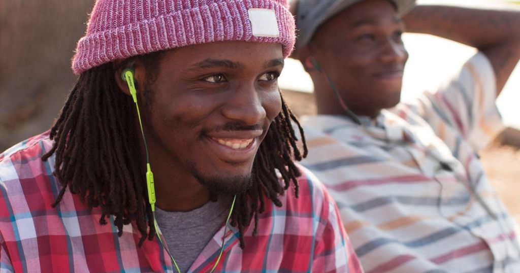 man wearing green Bose SoundSport Headphones