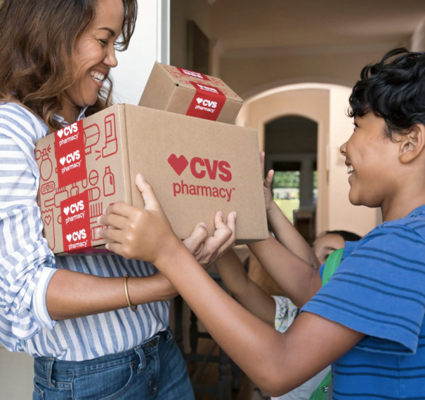 Woman holding CVS Pharmacy boxes