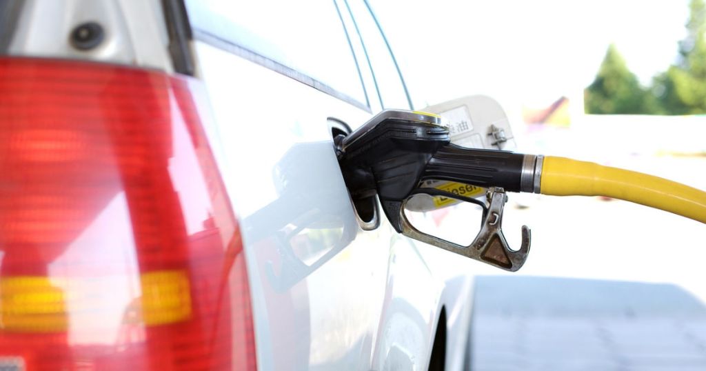 white car fueling up on gas