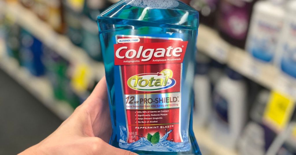 woman hand holding Colgate Total Mouthwash