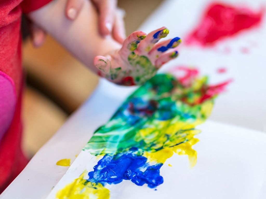 kid paining with Crayola finger paints