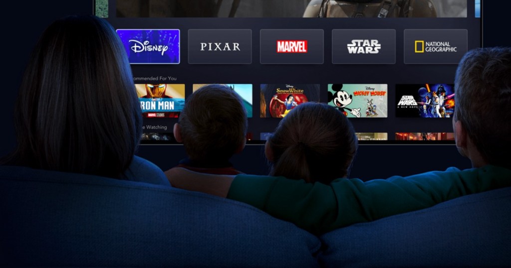 Family on couch watching Disney movies