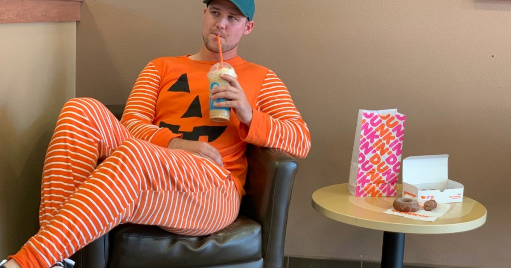Man in Pumpkin costume trying Dunkin Fall items