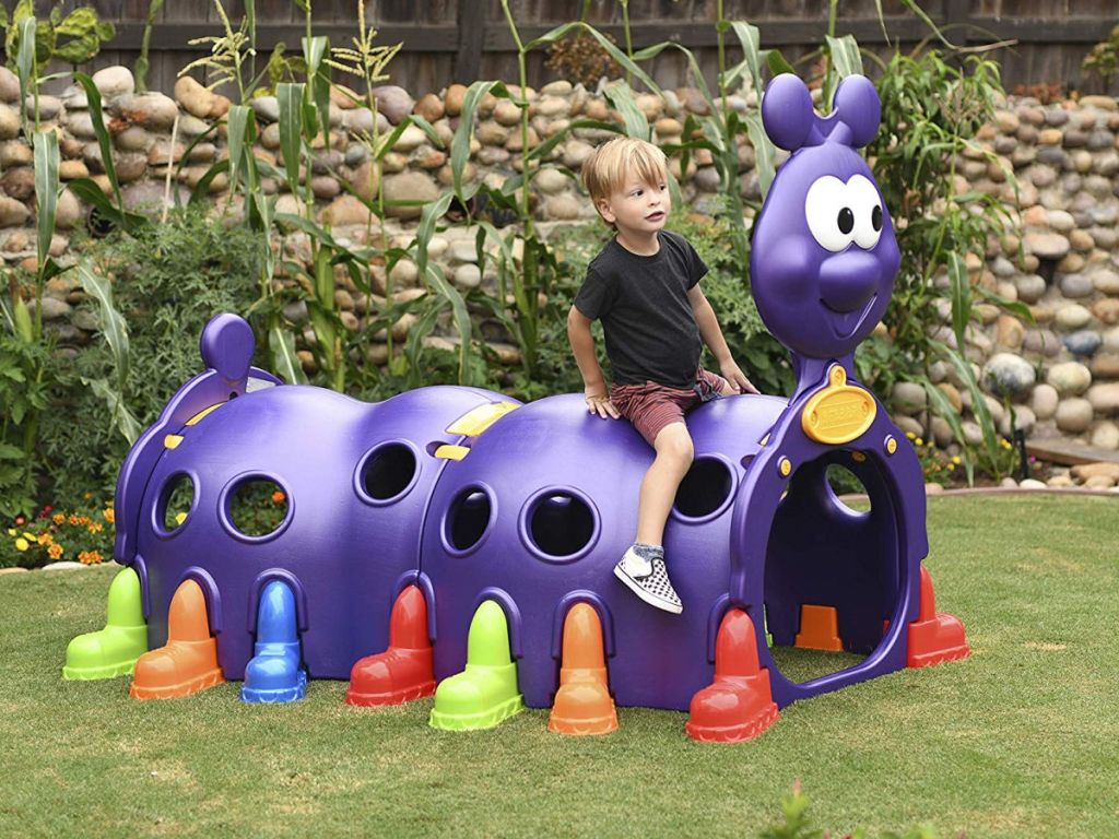 Boy sitting on ECR4Kids ELR-12511 Indoor/Outdoor Peek-A-Boo Caterpillar Climbing Play Structure for Kids