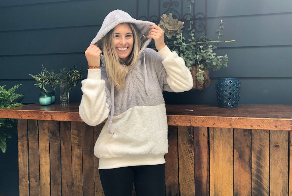 woman wearing color block fuzzy hoodie