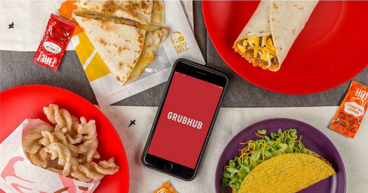 Taco Bell tacos, burrito, quesadillas and cinnamon twists near cell phone