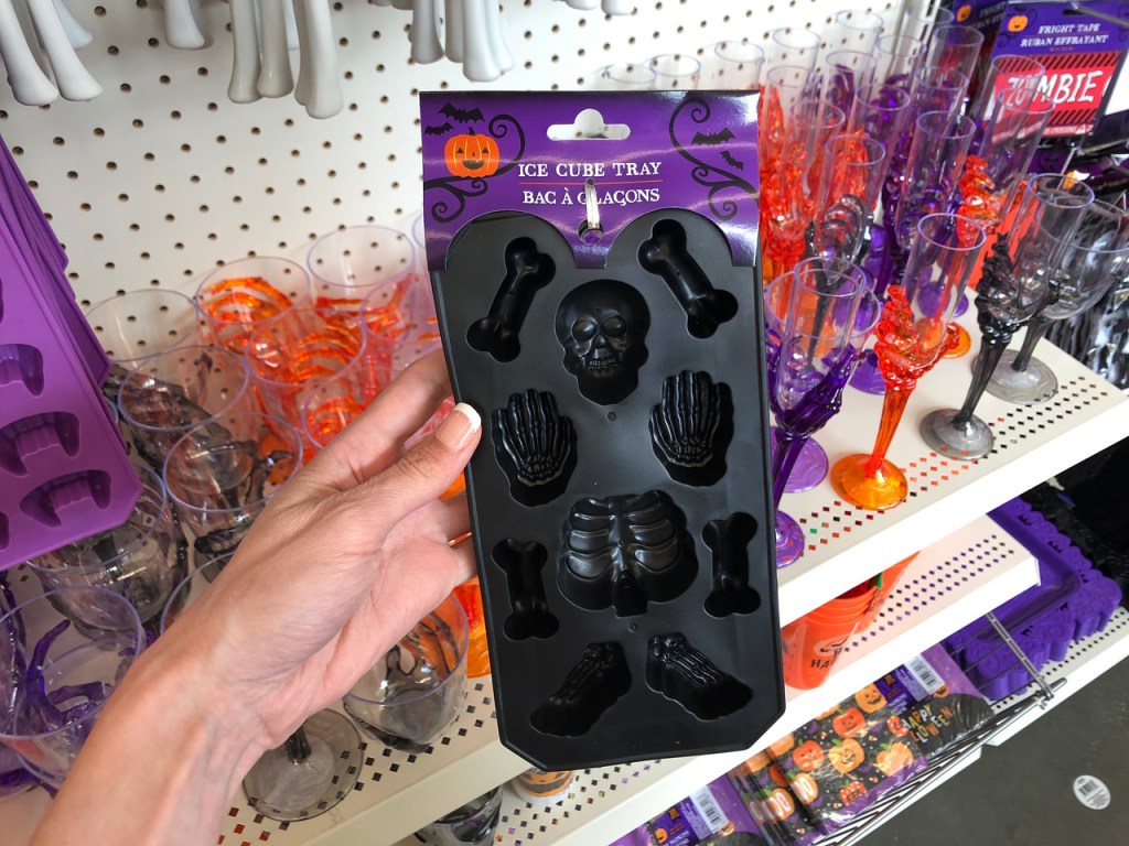 hand holding black ice tray in halloween shapes