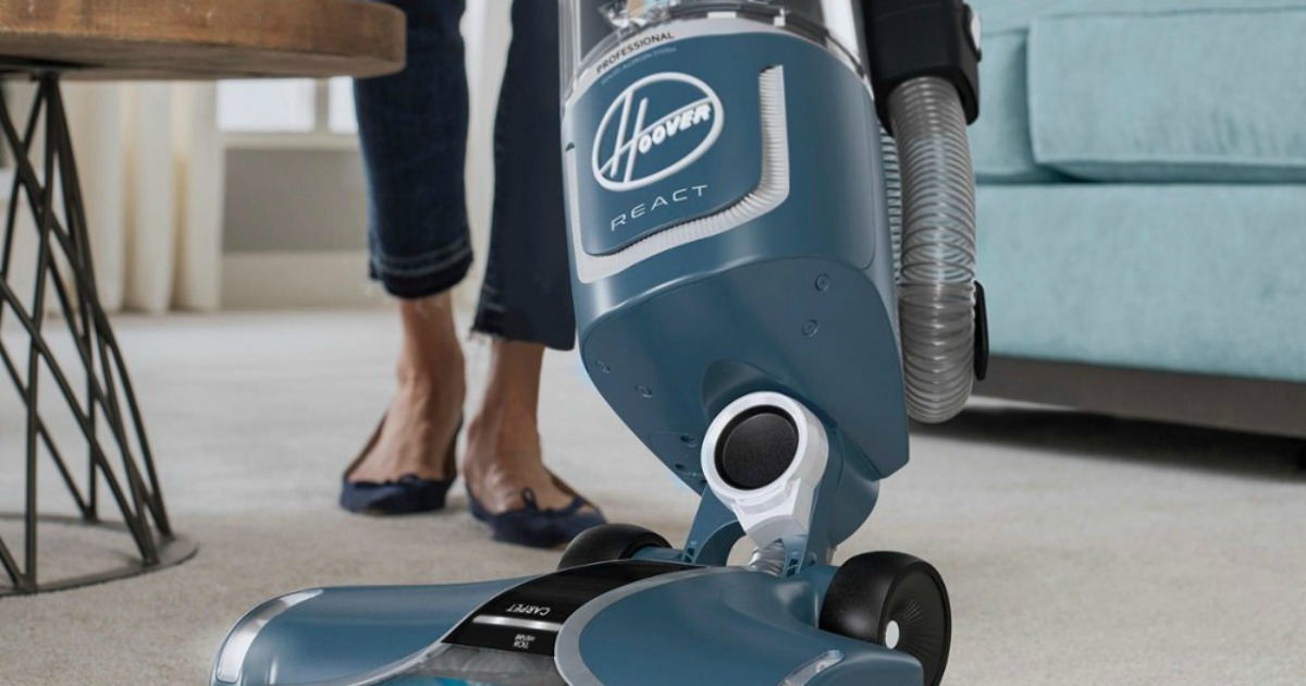 woman using a Hoover REACT vacuum to clean the rug