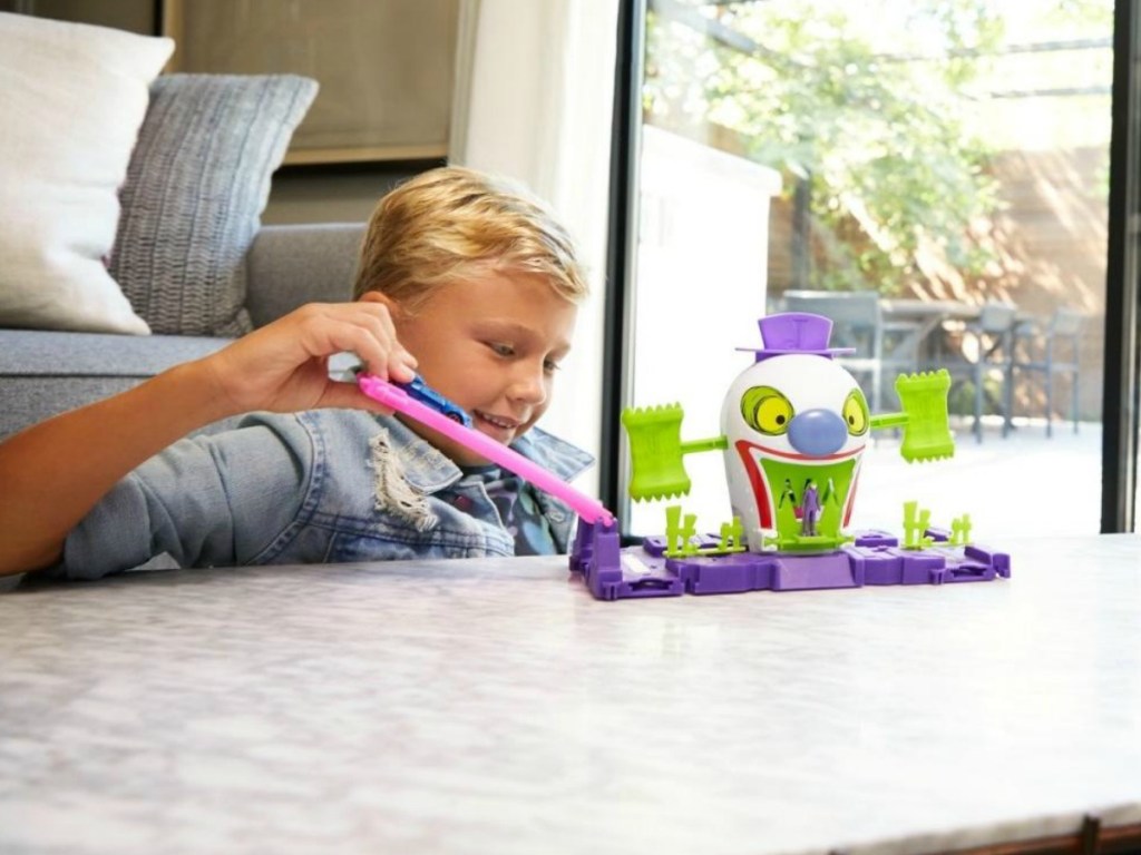 little boy playing with a Hot Wheels toy