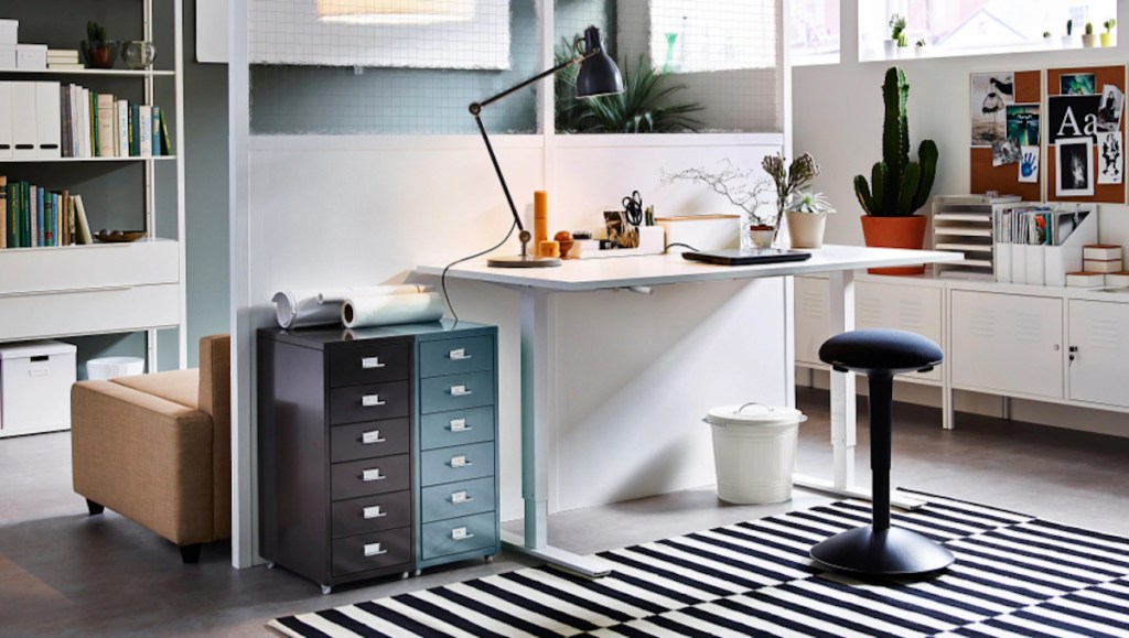 white ikea desk in office with light and stool