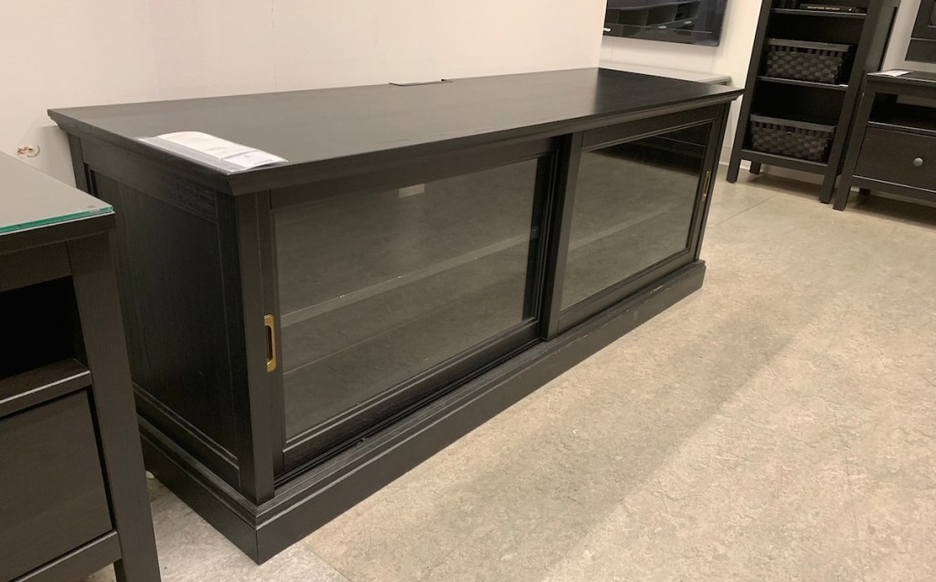 navy blue tv stand with glass doors in ikea store