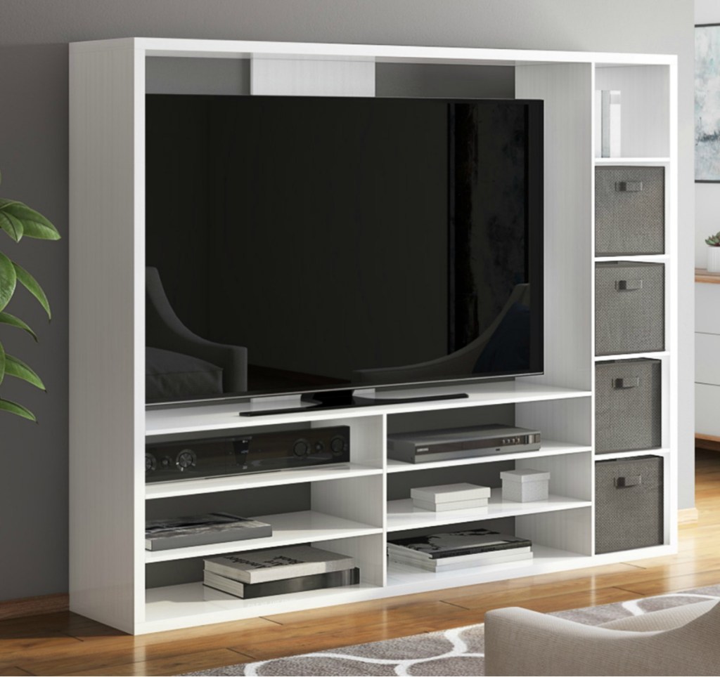 Mainstays brand entertainment stand in living room with gray fabric bins