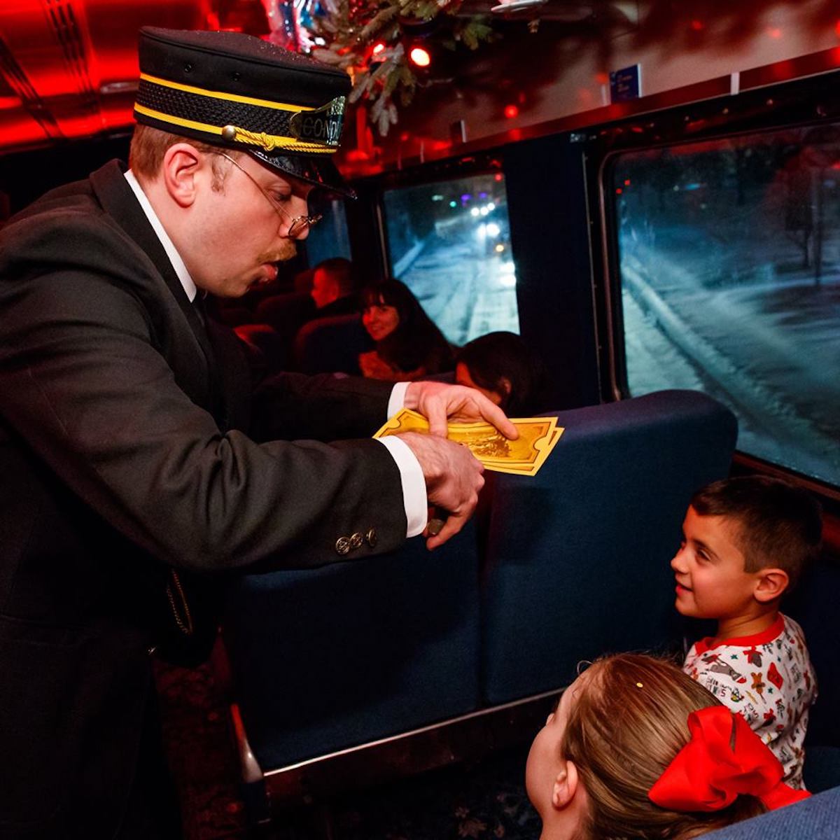 Train conductor clipping ticket on The Polar Express Train