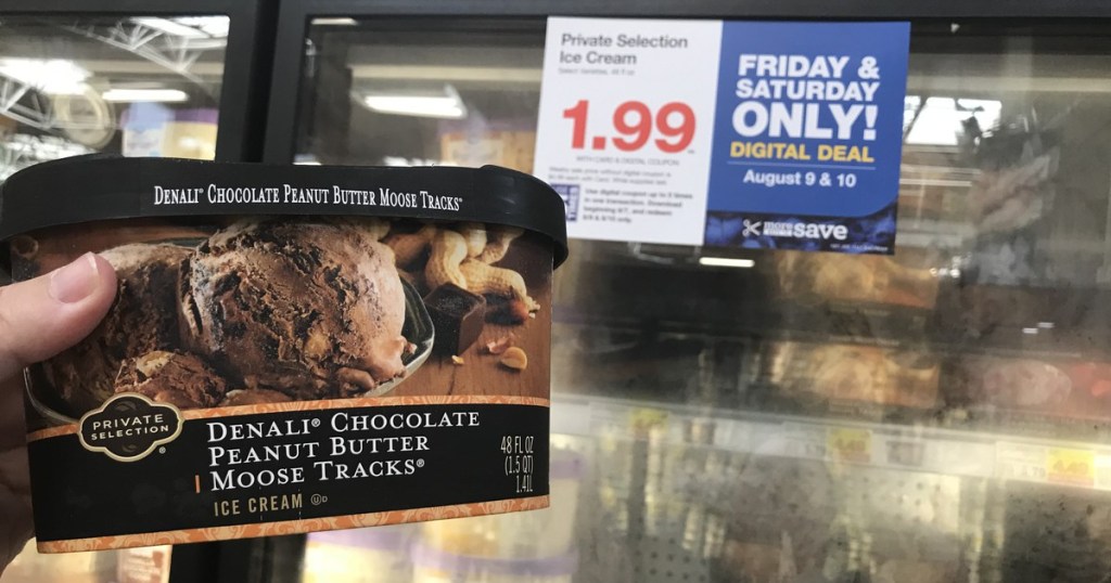 woamn holding container of private selection ice cream at kroger