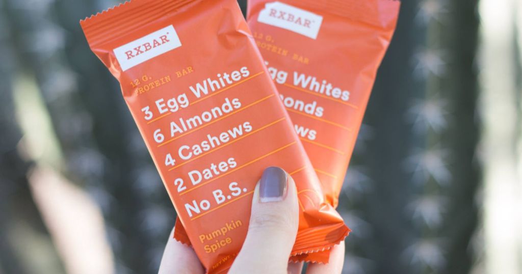 hand holding two pumpkin spice rxbar protein bars