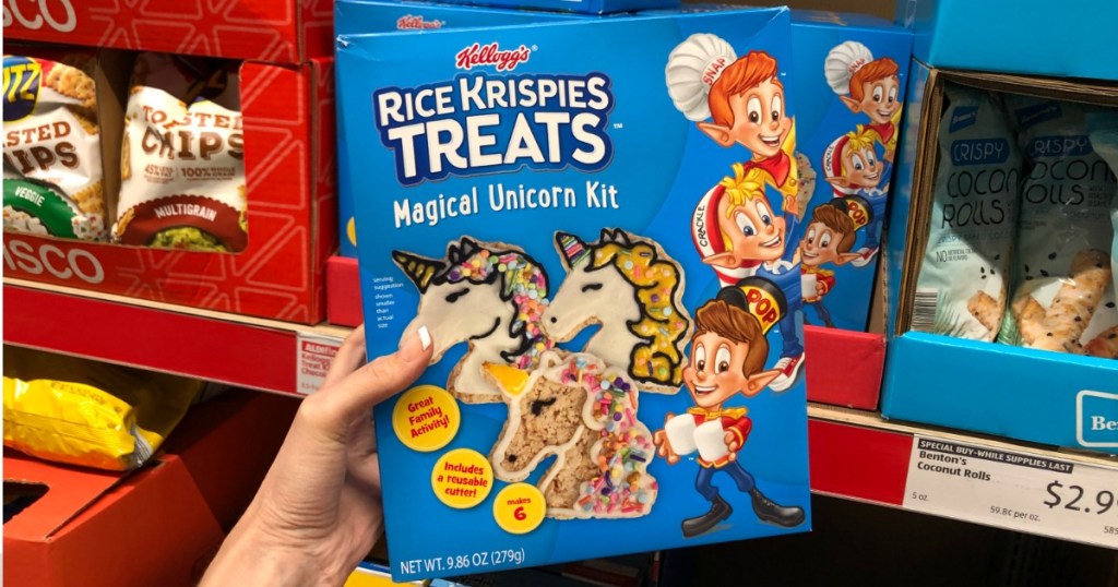 Woman holding box of Rice Krispies Treats Magical Unicorn Kit at ALDI