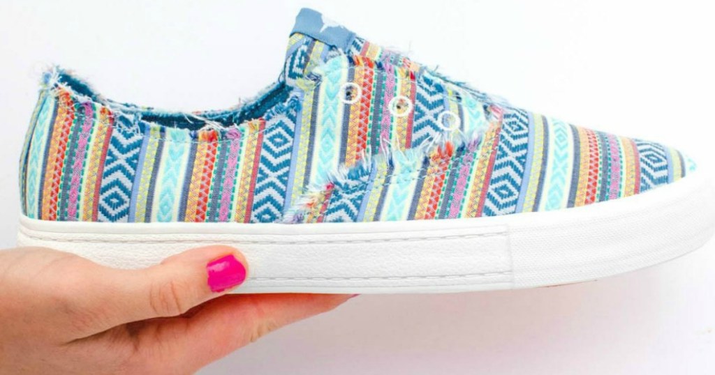 lady holding Rocket Dog sneakers