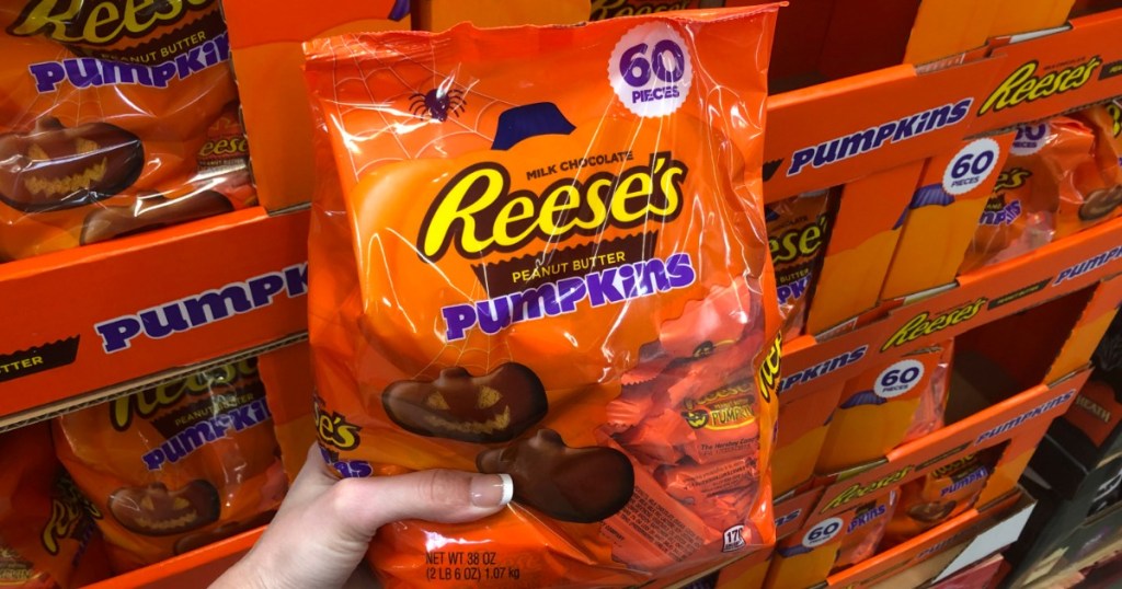 Woman holding Reese's Halloween Peanut Butter Pumpkins at Sam's Club