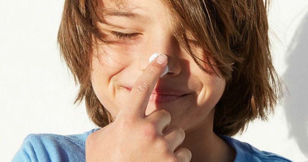 Boy with sunscreen on his nose