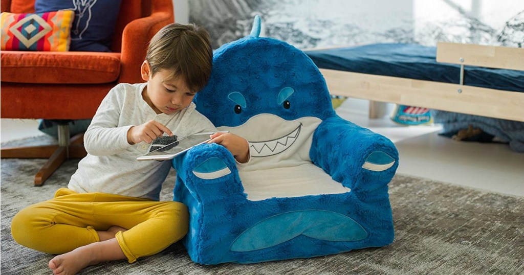 Boy reading next to Sweet Seats Shark Chair