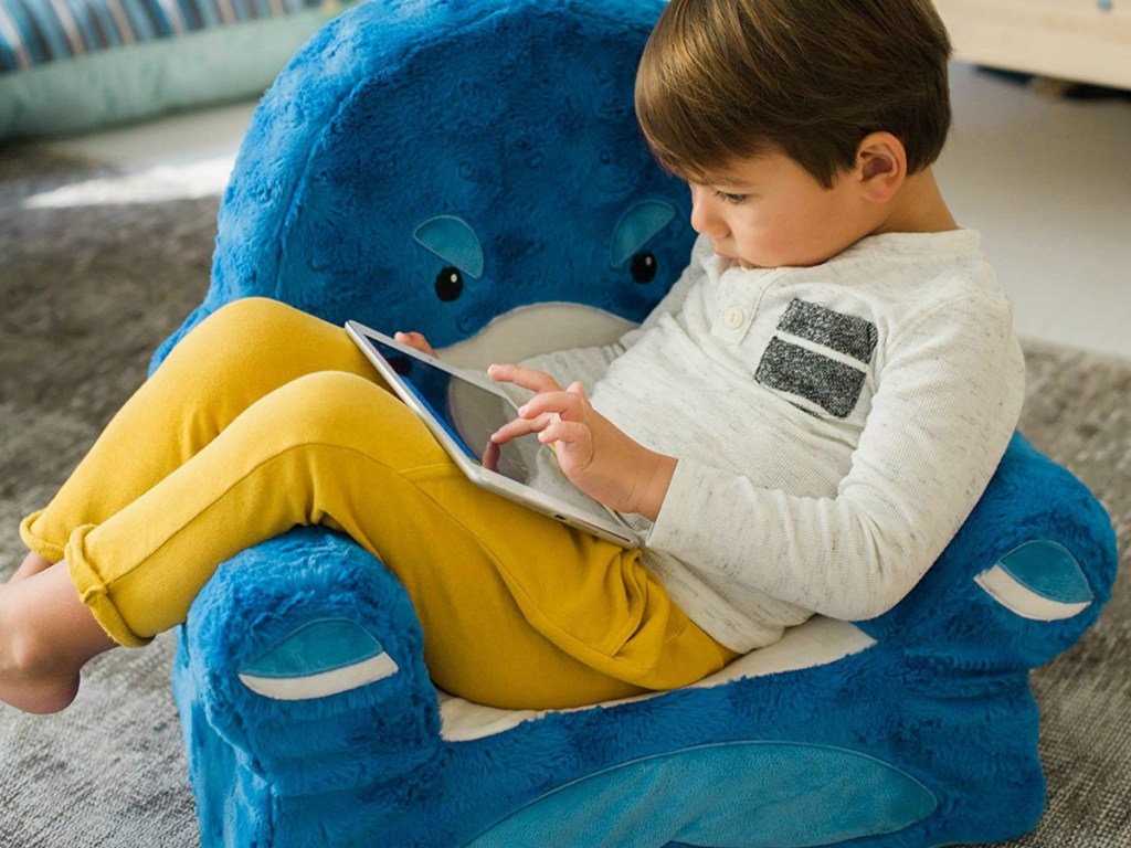 boy relaxing on Sweet Seats Shark Chair