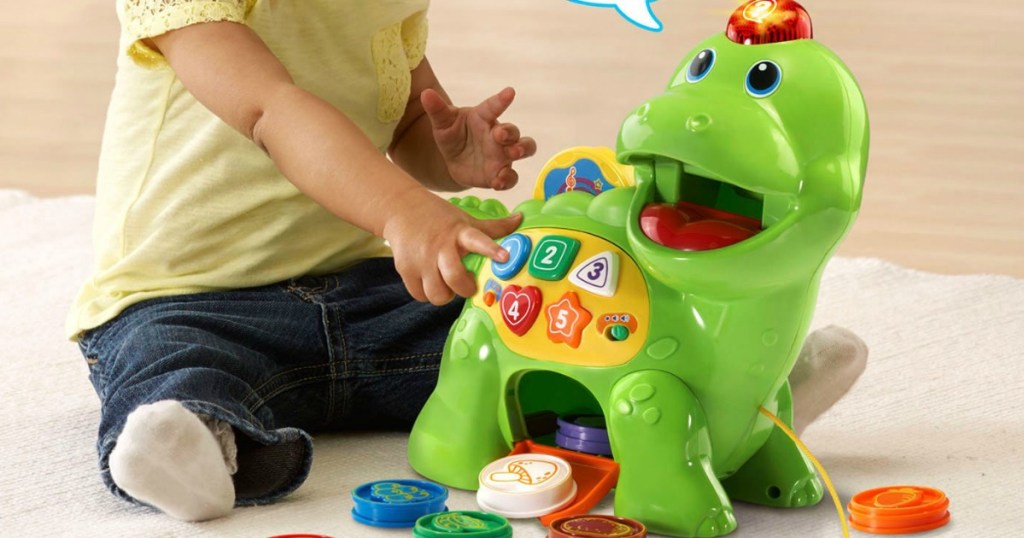child playing with toy dinosaur