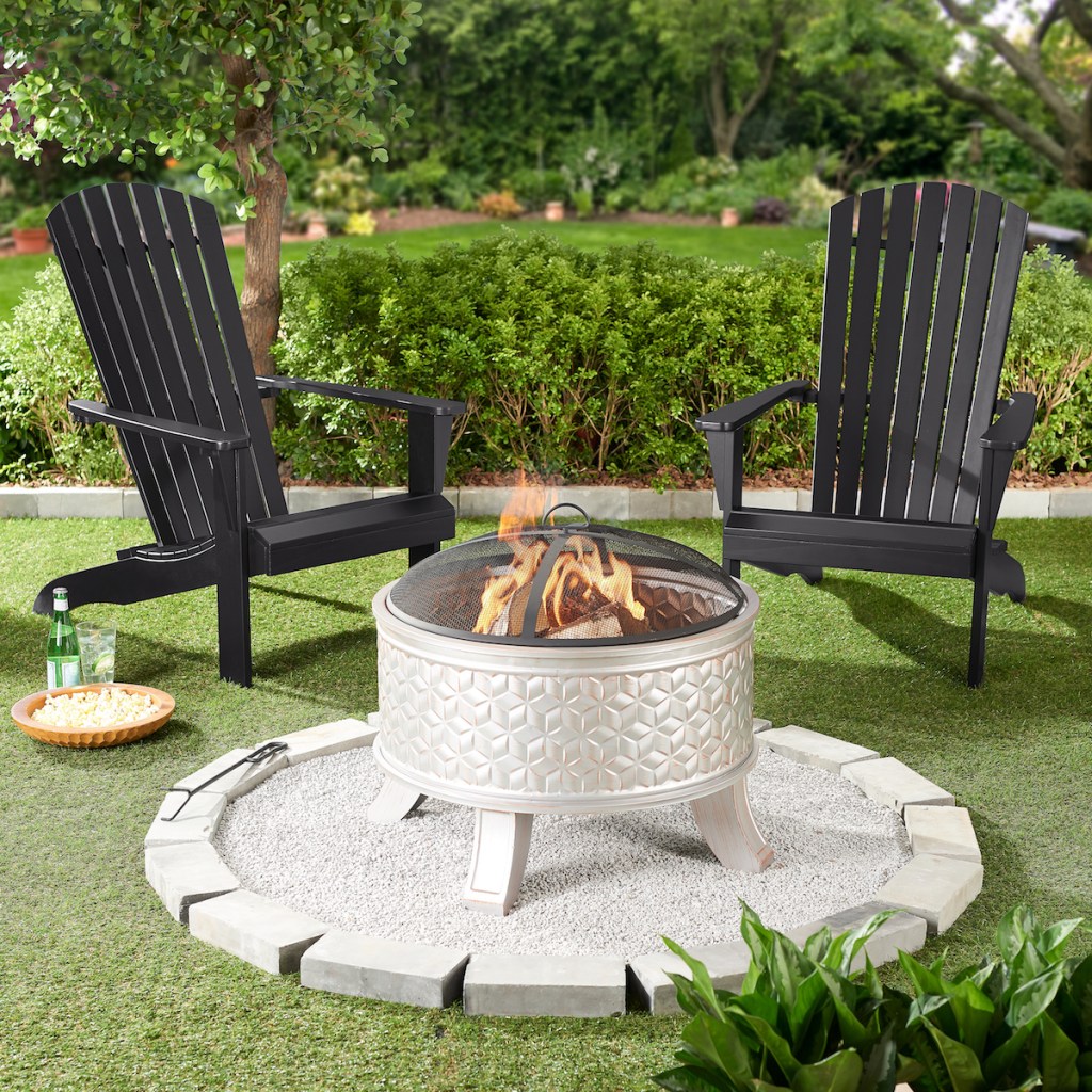 Mainstays Black Adirondack chairs around metal fire pit