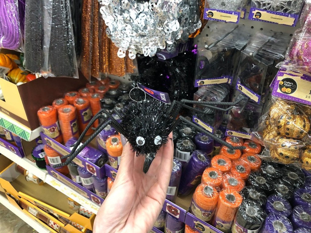 hand holding black tinsel spider